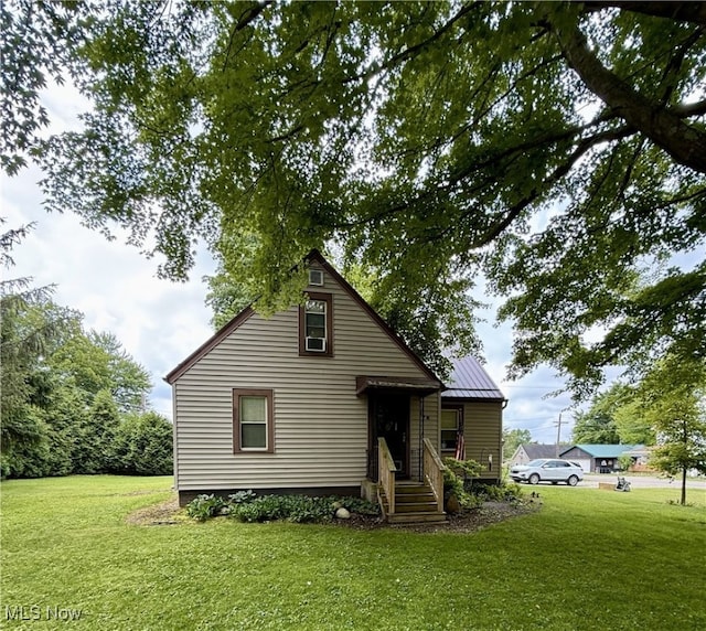 7 W Main St, Savannah, OH 44874 - bungalow-style house with a front lawn and a metal roof