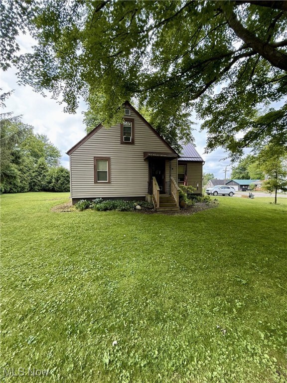 7 W Main St, Savannah, OH 44874 - view of front of property with a front lawn and a metal roof