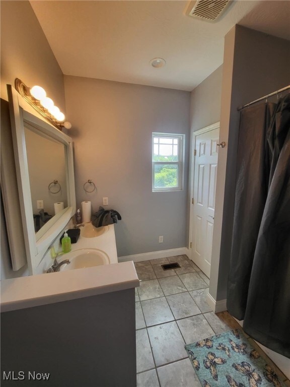 54856 Winding Hill Rd, Bellaire, OH 43906 - bathroom featuring vanity, a shower with shower curtain, and tile patterned floors