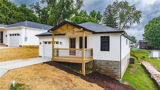 1404 15th St, Vienna, WV 26105 - modern farmhouse featuring a garage, driveway, roof with shingles, and board and batten siding