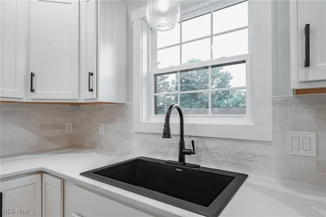 1404 15th St, Vienna, WV 26105 - kitchen with white cabinetry, light countertops, backsplash, and pendant lighting