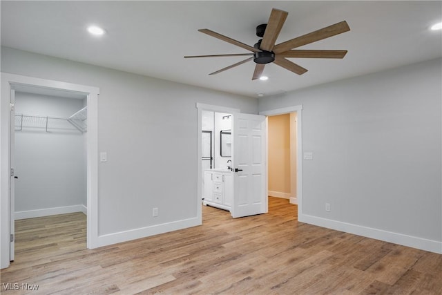 1404 15th St, Vienna, WV 26105 - unfurnished bedroom with a spacious closet, light wood-style flooring, recessed lighting, ensuite bathroom, and a closet