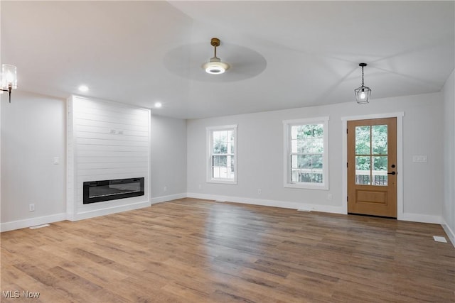 1404 15th St, Vienna, WV 26105 - unfurnished living room featuring plenty of natural light, a ceiling fan, a large fireplace, wood finished floors, and recessed lighting