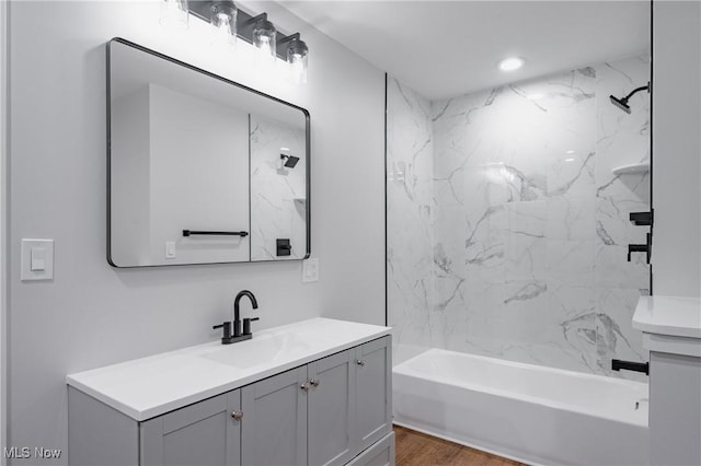 1404 15th St, Vienna, WV 26105 - bathroom with vanity, washtub / shower combination, and wood finished floors