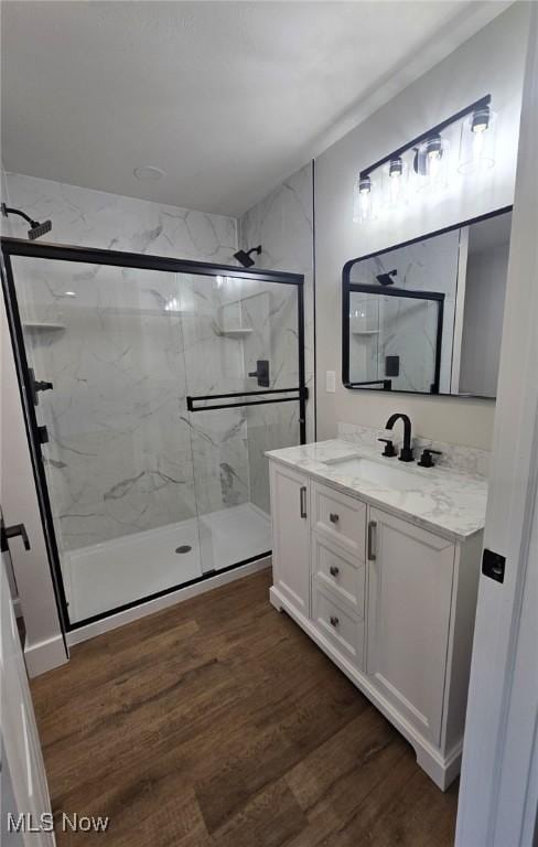 1404 15th St, Vienna, WV 26105 - full bathroom with a marble finish shower, vanity, and wood finished floors