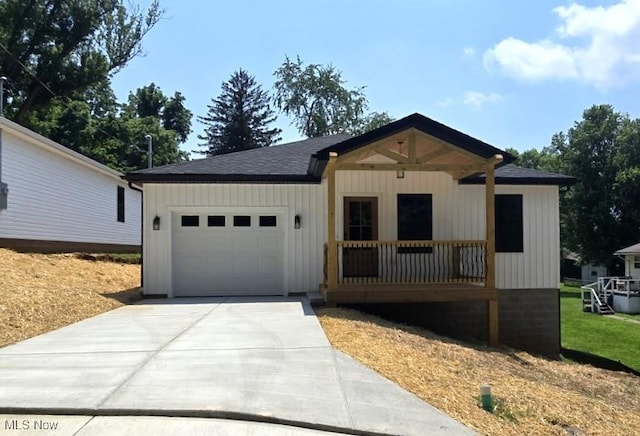 1404 15th St, Vienna, WV 26105 - view of front of home featuring a garage, concrete driveway, and a shingled roof