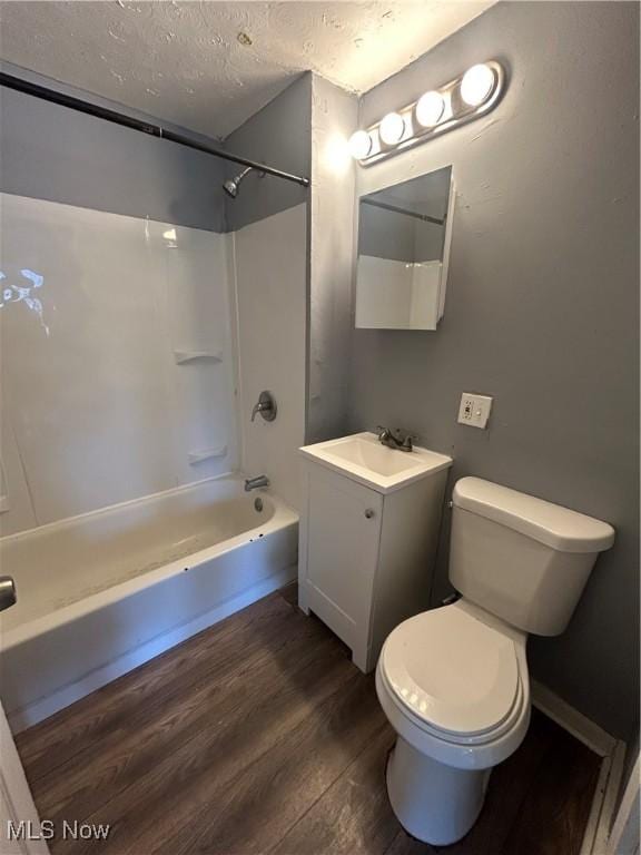 3568 E 114th St, Cleveland, OH 44105 - bathroom featuring wood finished floors, bathing tub / shower combination, vanity, and a textured ceiling