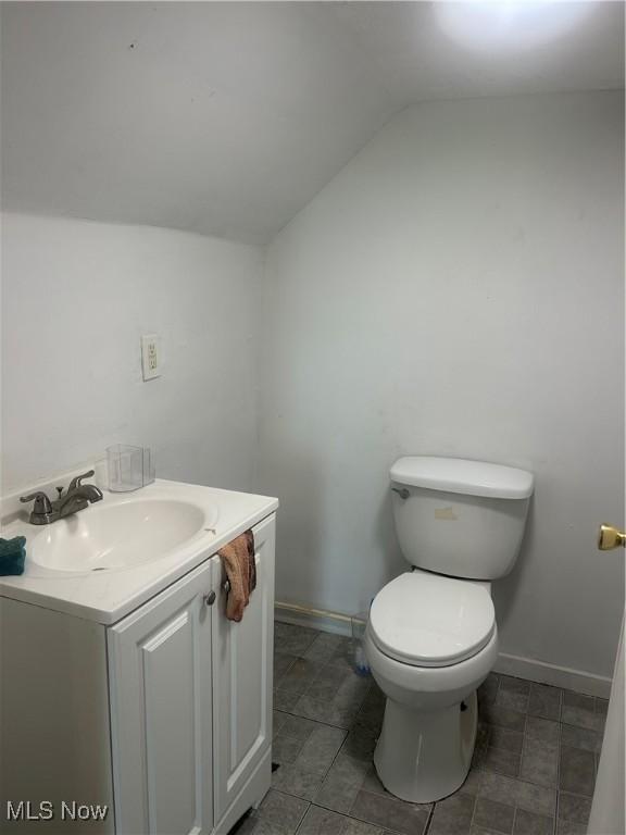 3568 E 114th St, Cleveland, OH 44105 - half bathroom featuring vaulted ceiling and vanity