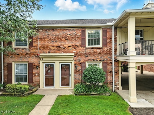 5830 Spotswood Dr, Lyndhurst, OH 44124 - multi unit property featuring a balcony, brick siding, and a front lawn