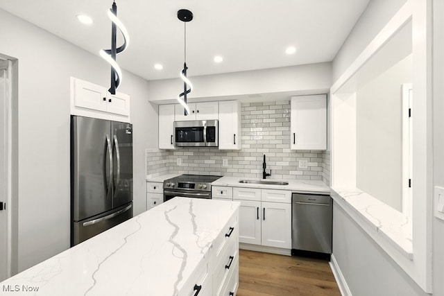 5830 Spotswood Dr, Lyndhurst, OH 44124 - kitchen with appliances with stainless steel finishes, decorative backsplash, light wood finished floors, white cabinetry, and light stone countertops