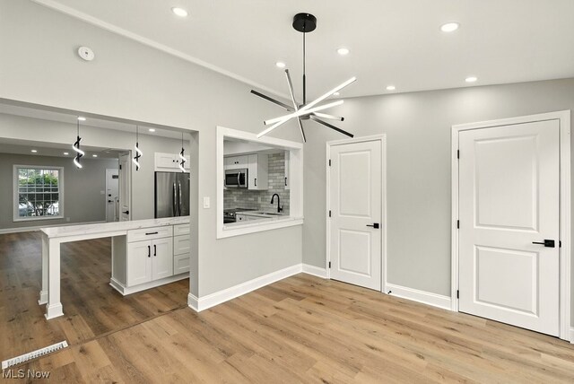 5830 Spotswood Dr, Lyndhurst, OH 44124 - unfurnished dining area featuring light wood-style floors, recessed lighting, and a chandelier
