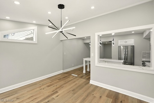 5830 Spotswood Dr, Lyndhurst, OH 44124 - unfurnished living room with light wood-type flooring, recessed lighting, and a chandelier