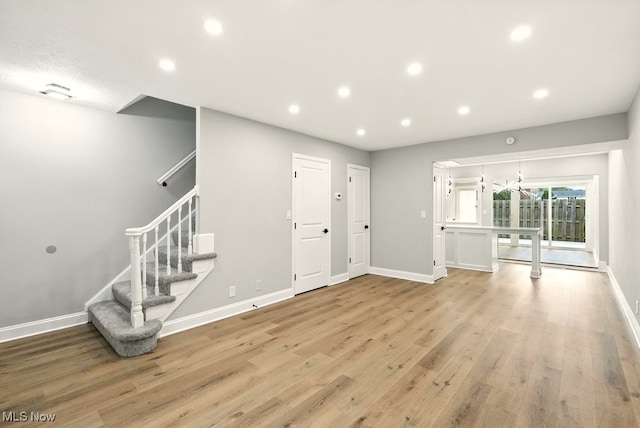 5830 Spotswood Dr, Lyndhurst, OH 44124 - unfurnished living room with recessed lighting, light wood finished floors, and stairs