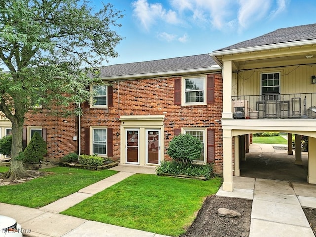 5830 Spotswood Dr, Lyndhurst, OH 44124 - view of front of house featuring a front lawn, a shingled roof, brick siding, and a balcony