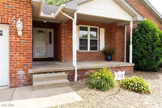 313 Crimson Cir, Campbell, OH 44405 - property entrance featuring covered porch and brick siding