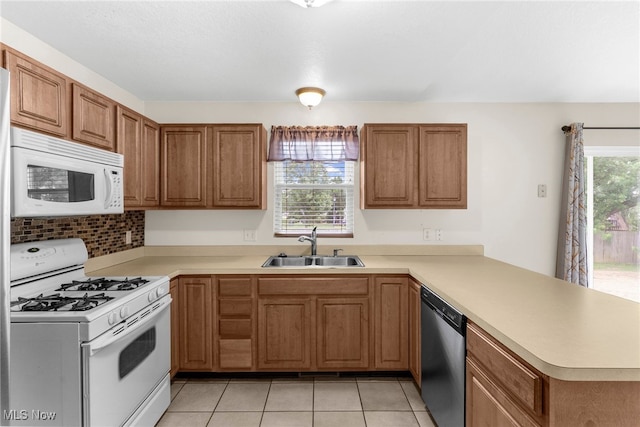 313 Crimson Cir, Campbell, OH 44405 - kitchen with white appliances, a peninsula, light countertops, and brown cabinets