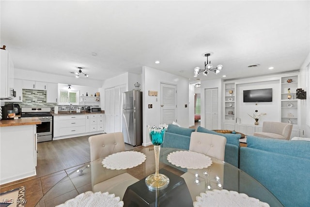 929 Moneta Ave, Aurora, OH 44202 - dining space with a chandelier, recessed lighting, built in shelves, and tile patterned flooring