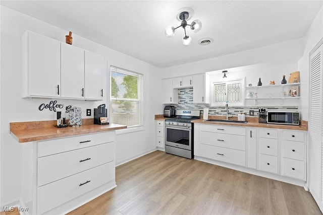 929 Moneta Ave, Aurora, OH 44202 - kitchen featuring stainless steel gas stove, light wood-style flooring, white cabinets, and light countertops