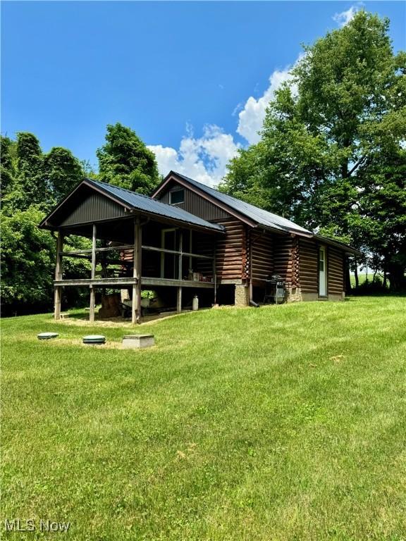 1917 Township Road 26, Killbuck, OH 44637 - back of house featuring log siding and a yard