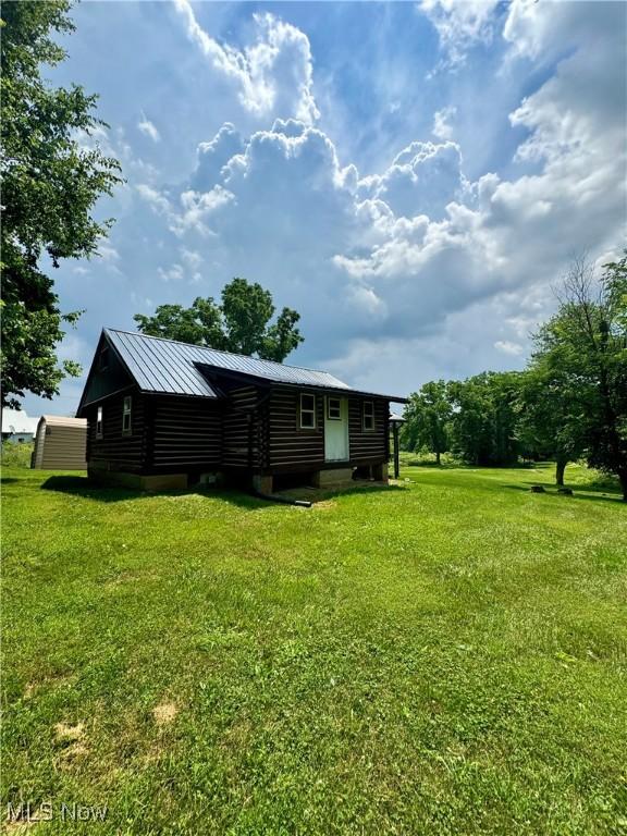 1917 Township Road 26, Killbuck, OH 44637 - back of house with a yard and a metal roof