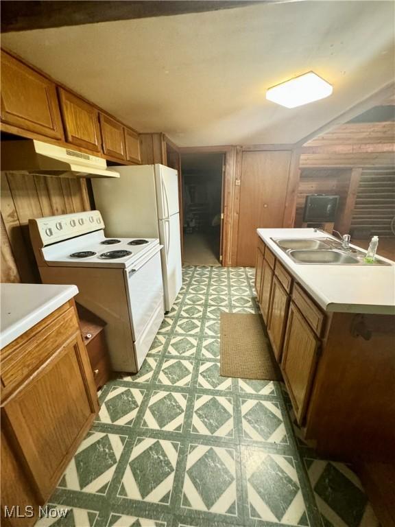 1917 Township Road 26, Killbuck, OH 44637 - kitchen with white electric stove, light floors, under cabinet range hood, brown cabinetry, and light countertops