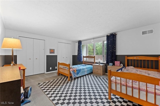 2632 S Green Rd, University Heights, OH 44122 - bedroom with two closets and a textured ceiling