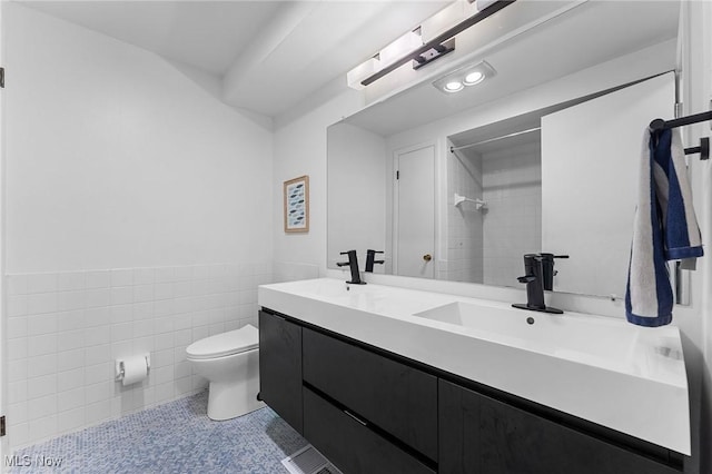 2632 S Green Rd, University Heights, OH 44122 - bathroom with tile walls, double vanity, wainscoting, a shower, and tile patterned flooring