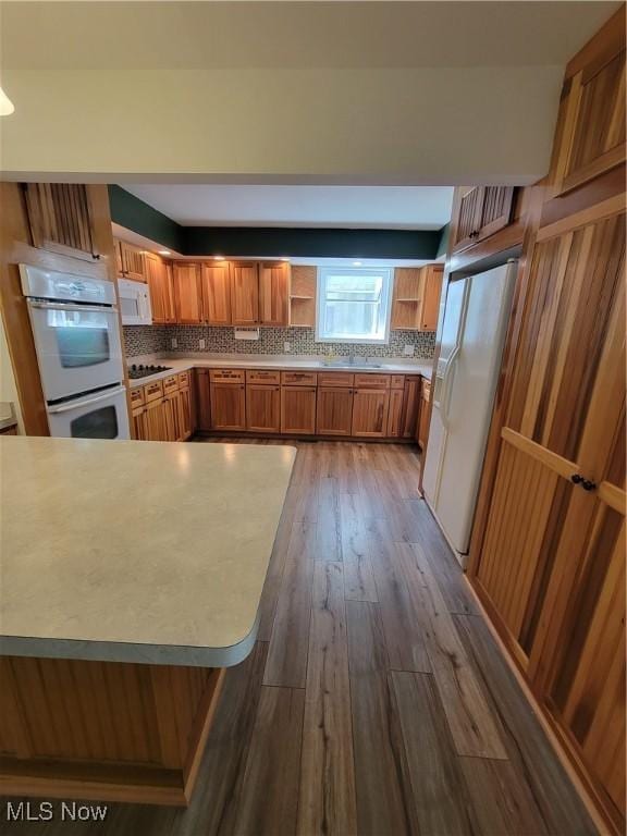 262 High St, Conneaut, OH 44030 - kitchen with open shelves, white appliances, backsplash, and brown cabinetry