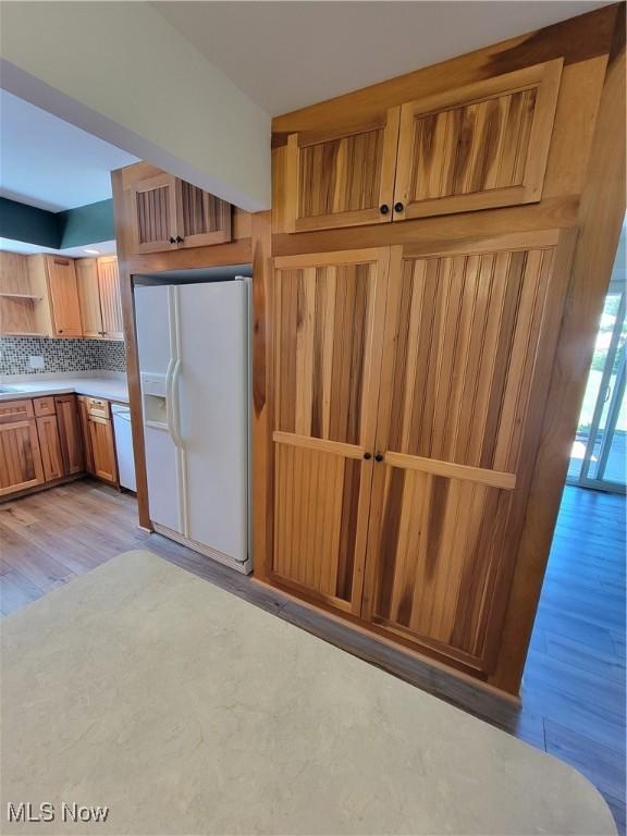 262 High St, Conneaut, OH 44030 - kitchen featuring white appliances, open shelves, light wood-type flooring, light countertops, and brown cabinetry
