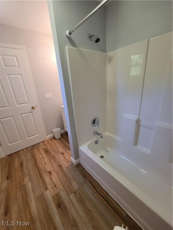 262 High St, Conneaut, OH 44030 - bathroom featuring shower / bathtub combination and wood finished floors