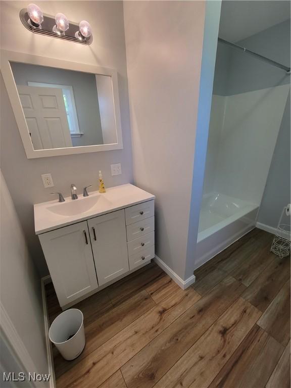 262 High St, Conneaut, OH 44030 - full bathroom with vanity, wood finished floors, and a shower