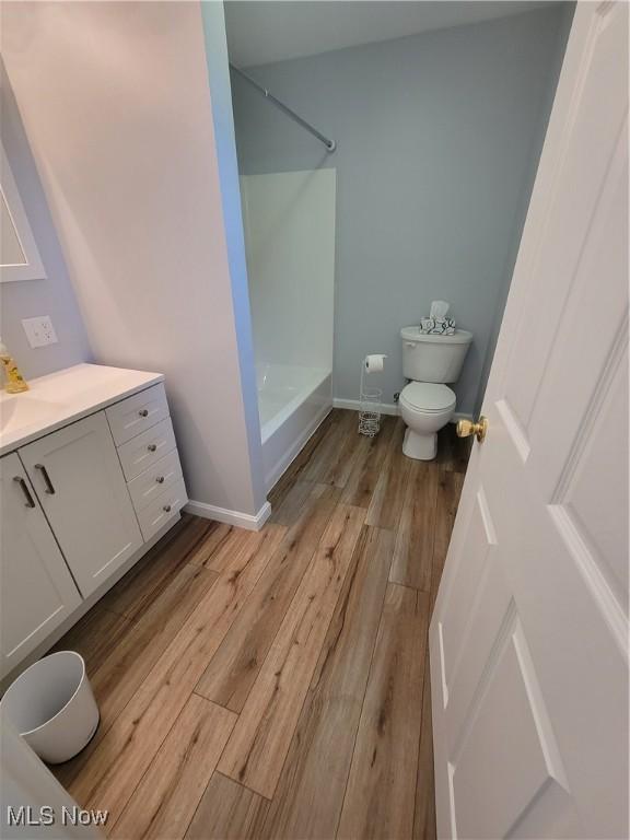 262 High St, Conneaut, OH 44030 - full bathroom with wood finished floors, vanity, and tub / shower combination