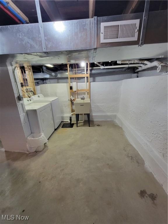 262 High St, Conneaut, OH 44030 - unfinished basement with washing machine and dryer and a sink