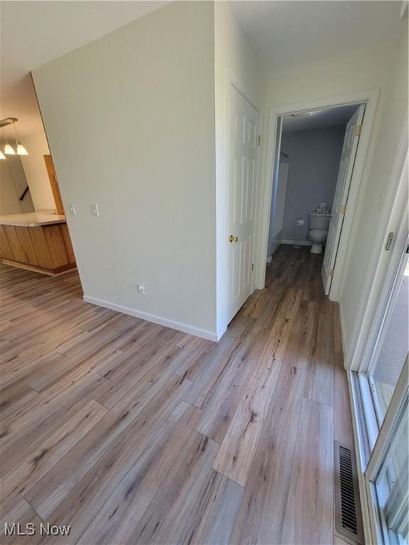 262 High St, Conneaut, OH 44030 - unfurnished living room with light wood-style floors and baseboards