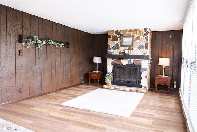 961 Slater Rd, Salem, OH 44460 - living room with wood finished floors, a stone fireplace, and wood walls