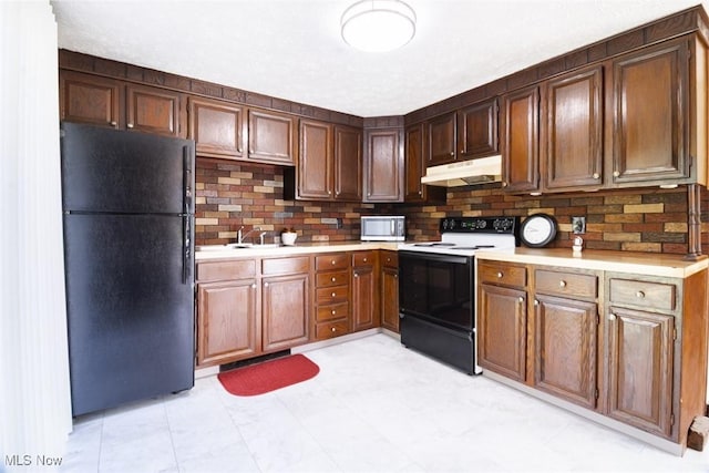 961 Slater Rd, Salem, OH 44460 - kitchen featuring freestanding refrigerator, range with electric cooktop, under cabinet range hood, stainless steel microwave, and light countertops