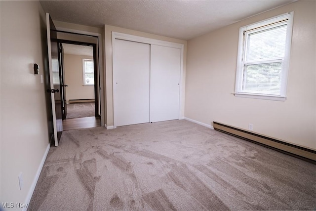 961 Slater Rd, Salem, OH 44460 - unfurnished bedroom with carpet, a baseboard heating unit, a closet, and a textured ceiling