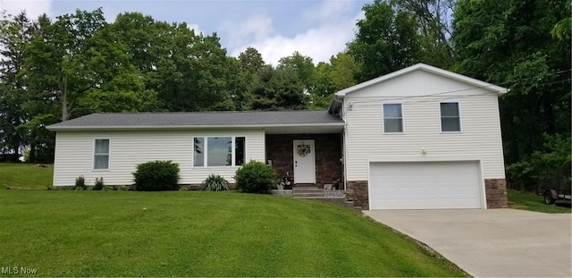 29928 Buck Rd, Salem, OH 44460 - tri-level home with a garage, a front lawn, driveway, and stone siding