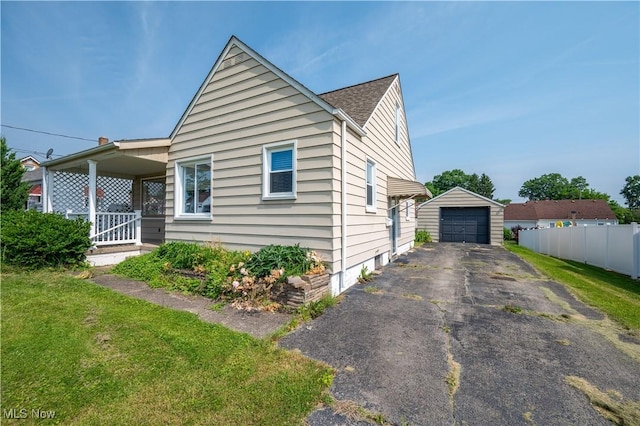 135 Renee Dr, Struthers, OH 44471 - view of front of house featuring an outdoor structure, asphalt driveway, and a garage