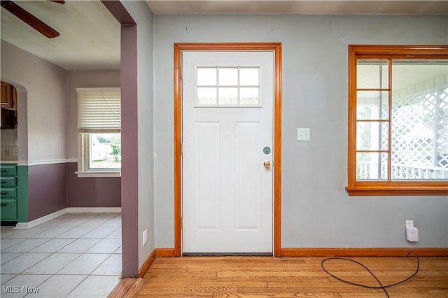135 Renee Dr, Struthers, OH 44471 - foyer entrance featuring arched walkways, ceiling fan, and light tile patterned flooring