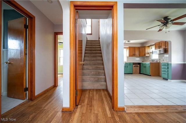 135 Renee Dr, Struthers, OH 44471 - stairway with ceiling fan, wood finished floors, and arched walkways