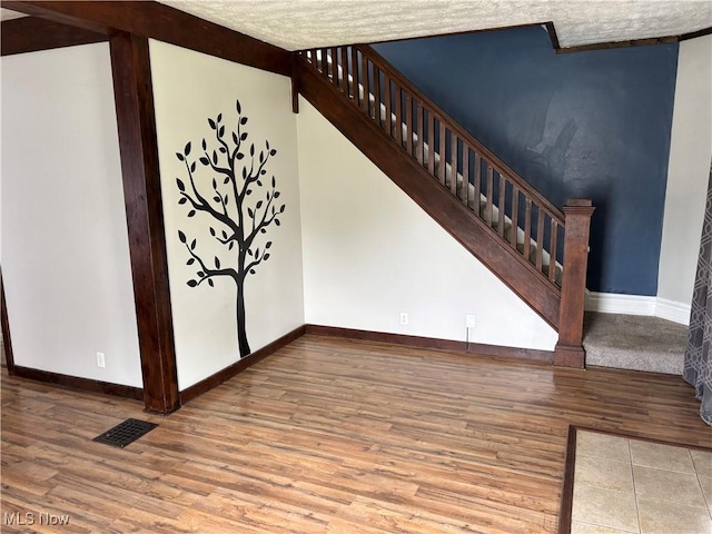 391 Cornell St, Akron, OH 44310 - unfurnished living room featuring wood finished floors and stairway