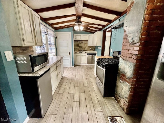 391 Cornell St, Akron, OH 44310 - kitchen featuring stainless steel appliances, wood finish floors, ceiling fan, light countertops, and decorative backsplash