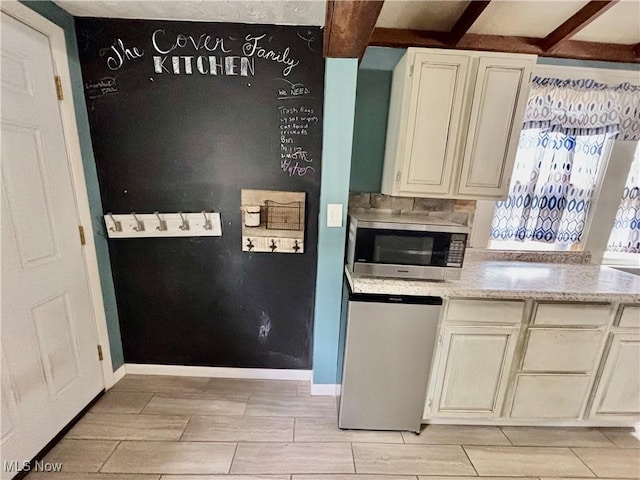 391 Cornell St, Akron, OH 44310 - kitchen with stainless steel microwave, beamed ceiling, wood finish floors, dishwashing machine, and light stone countertops