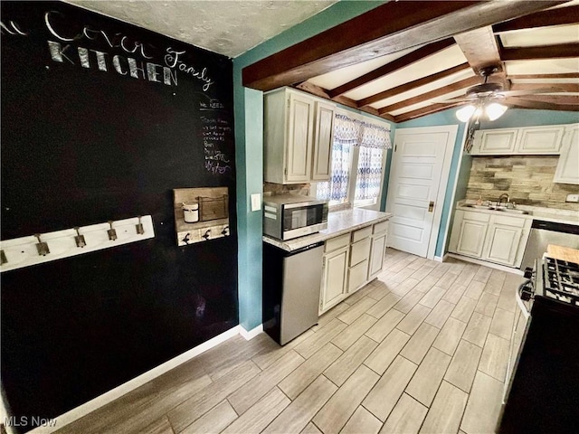 391 Cornell St, Akron, OH 44310 - kitchen featuring stainless steel appliances, decorative backsplash, a ceiling fan, light countertops, and light wood finished floors