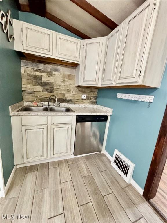 391 Cornell St, Akron, OH 44310 - kitchen featuring stainless steel dishwasher, wood finish floors, tasteful backsplash, and light countertops