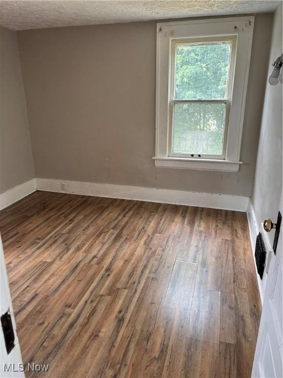 391 Cornell St, Akron, OH 44310 - unfurnished room with hardwood / wood-style flooring and a textured ceiling