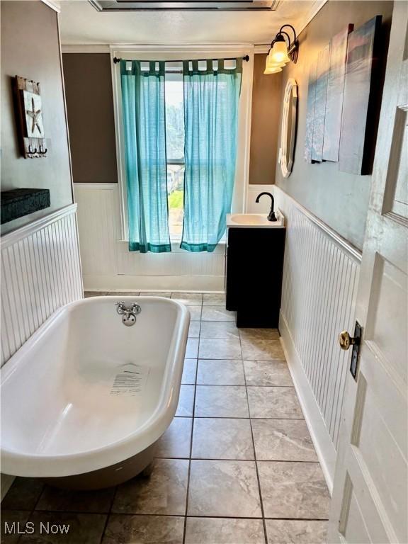 391 Cornell St, Akron, OH 44310 - bathroom with a freestanding tub, vanity, and wainscoting