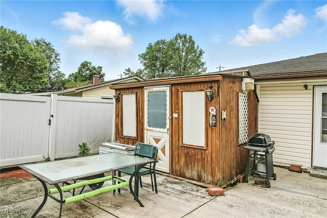 4477 S Warwick Dr, Canfield, OH 44406 - view of patio with outdoor dining area, area for grilling, a gate, and an outdoor structure