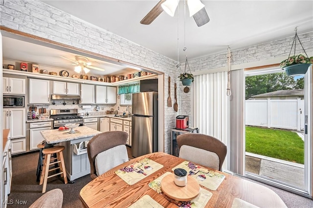 4477 S Warwick Dr, Canfield, OH 44406 - dining room featuring ceiling fan and brick wall